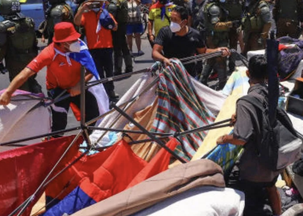 Chilean protestors tear down a makeshift Venezuelan migrant camp, January 2022 (source: BBC News, https://www.bbc.co.uk/news/world-latin-america-60197980)
